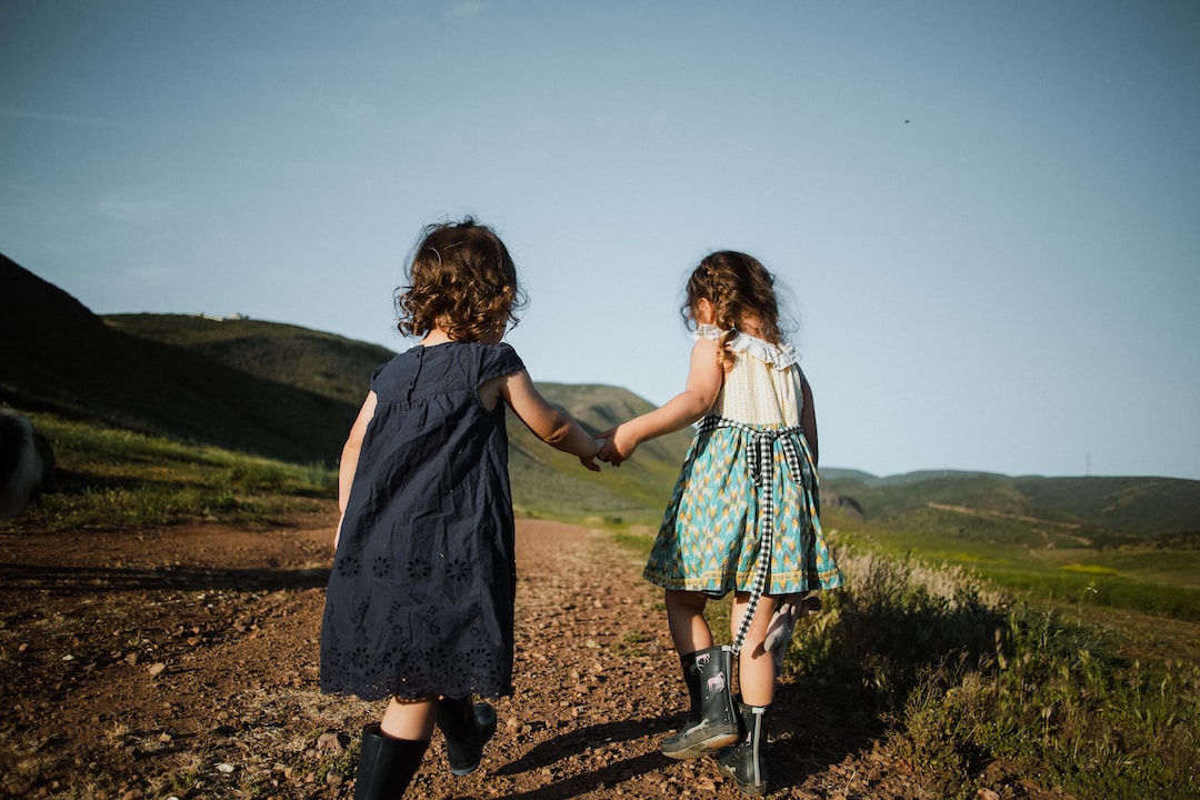 2 girls in blue dress standing on brown field during daytime xCU7nCMNfI8 jpg