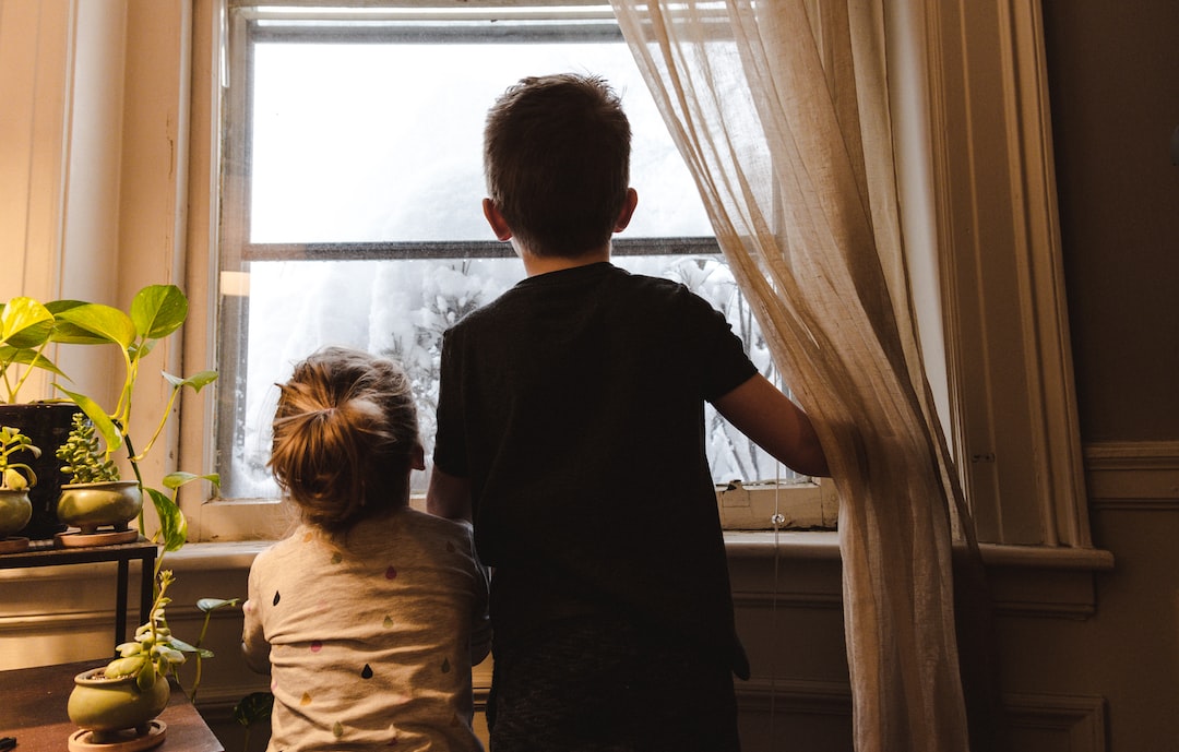 boy and girl standing near window looking outside 4l2Ml8 MLUg jpg