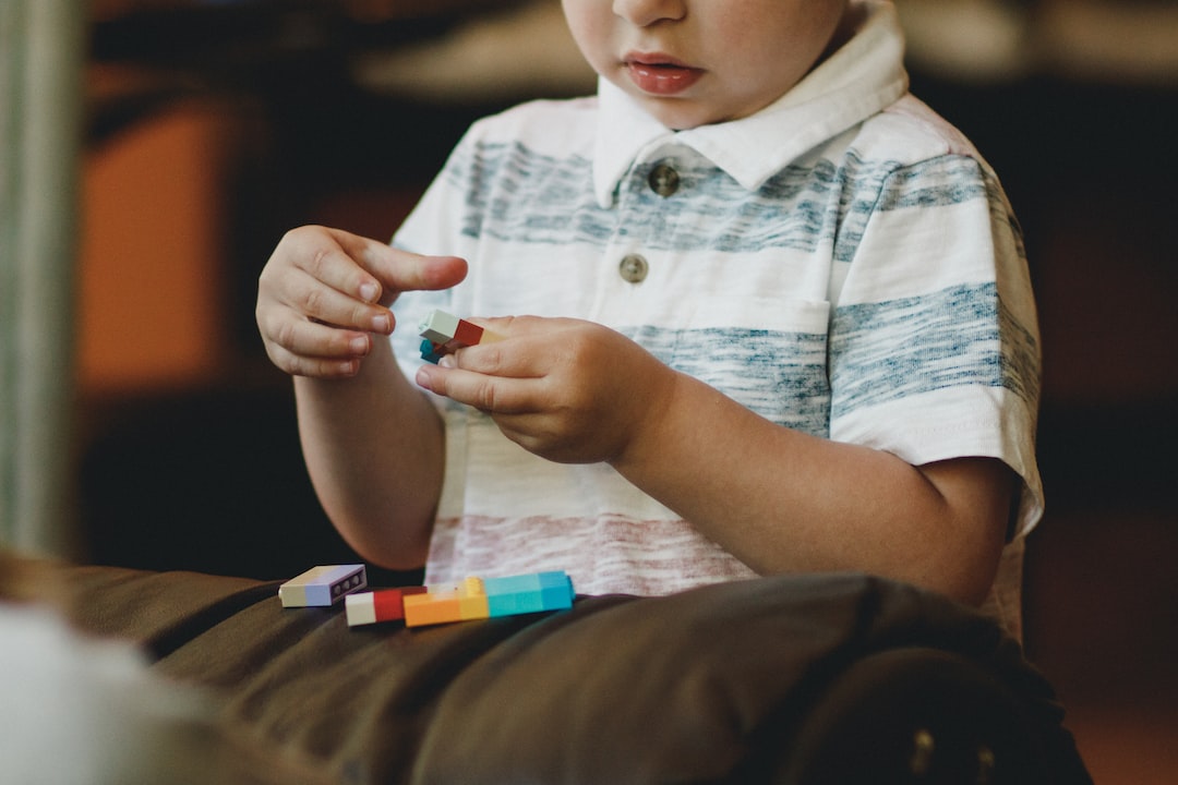 boy holding block toy ecRuhwPIW7c jpg