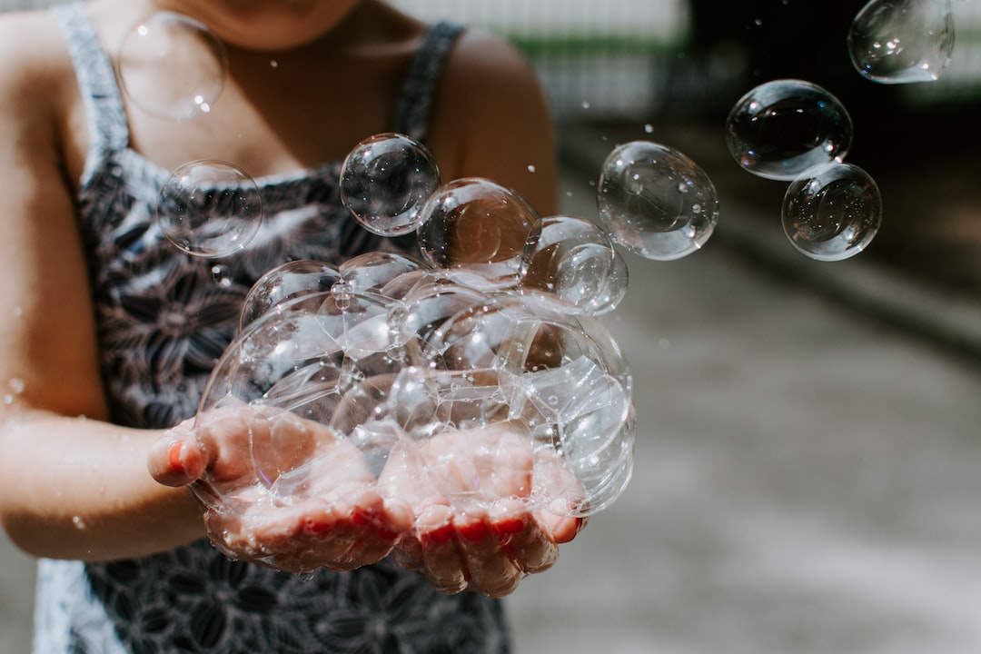 person holding soap bubbles outdoors hUuGUG9gdRg jpg